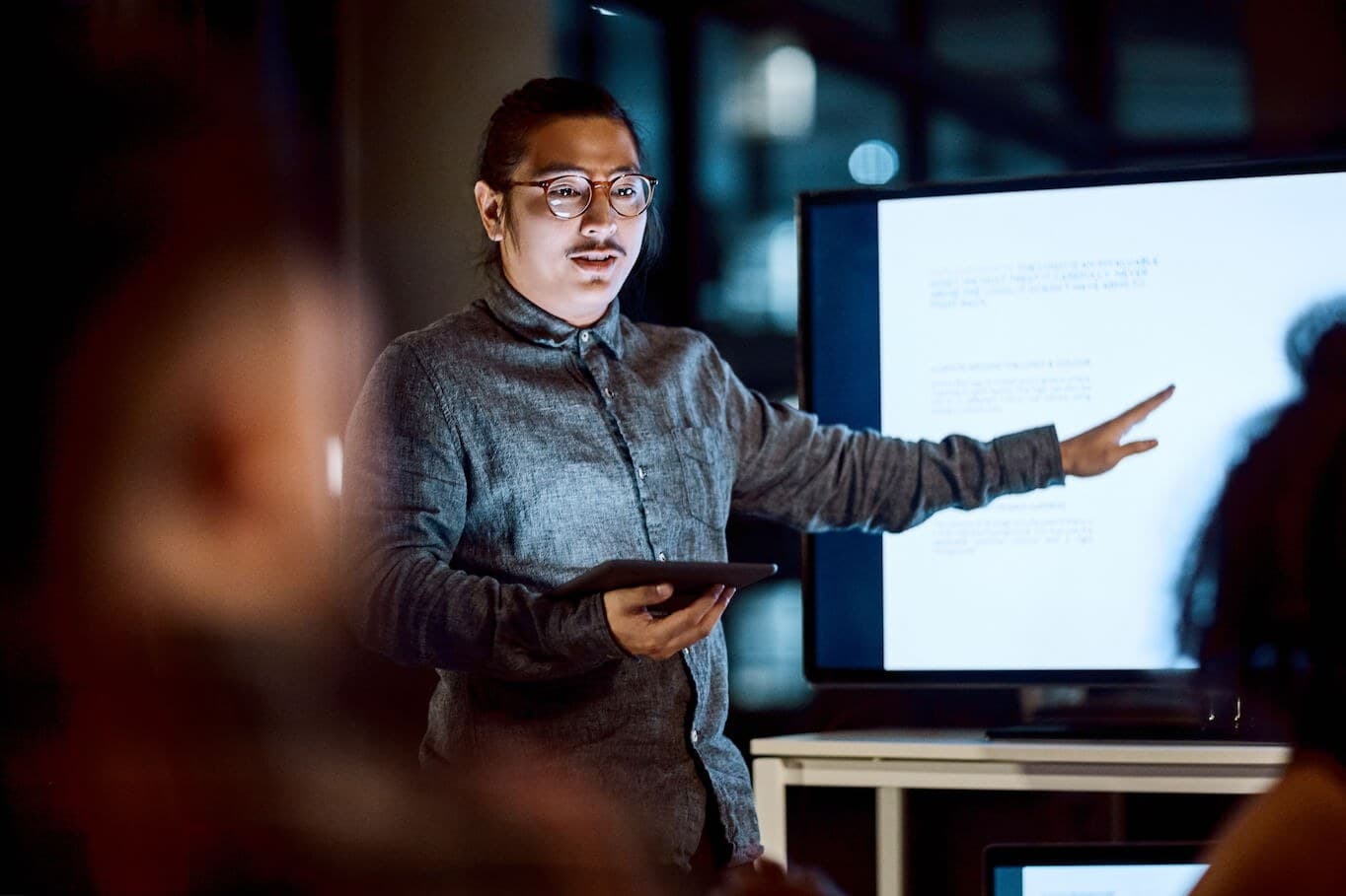 Man pointing to big screen