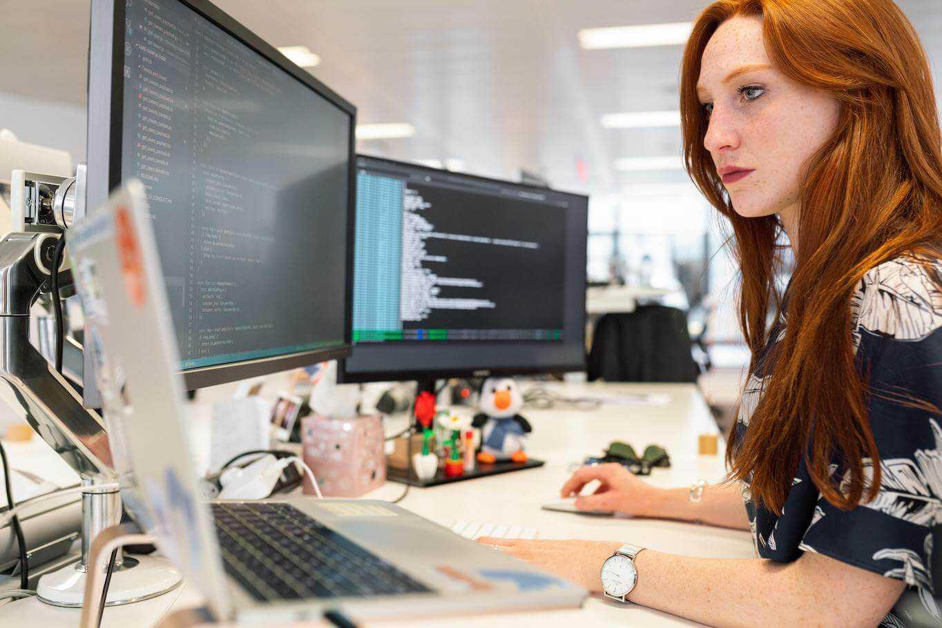 Woman programming behind computer